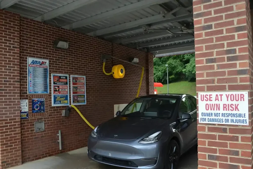 Car wash station with warning sign